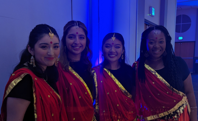 Four women, each wearing a Sari