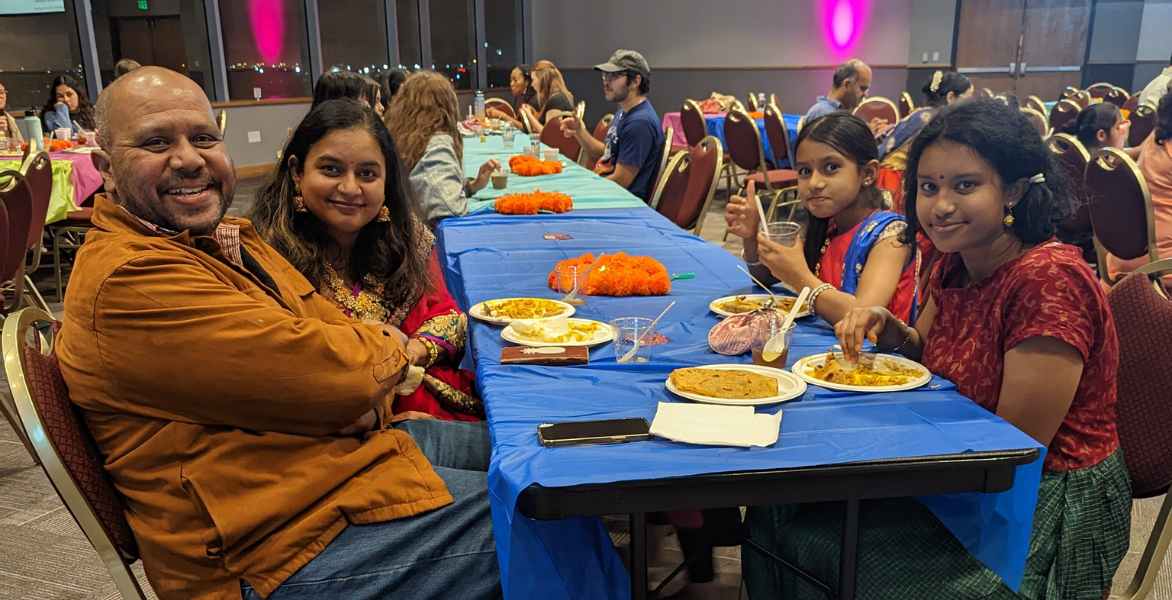 A family enjoyes food at the Diwali event