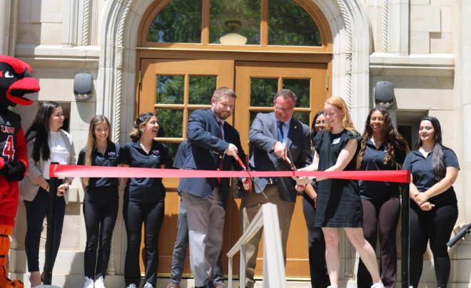 (L-R Front Row): Dr. Chris Summerlin, Dr. Thomas M. Evans and Marissa Watters, Residence Life Graduate Area Coordinator, cut the ribbon to officially reopen Dubuis Hall  