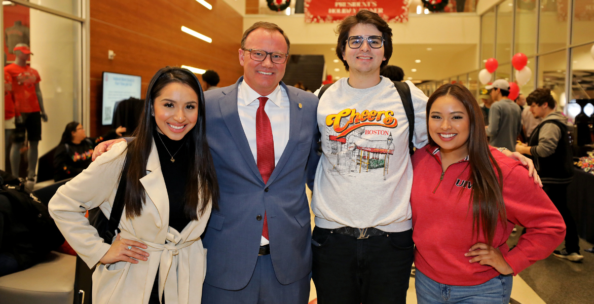 Dr. Thomas M. Evans, PhD, and three UIW students