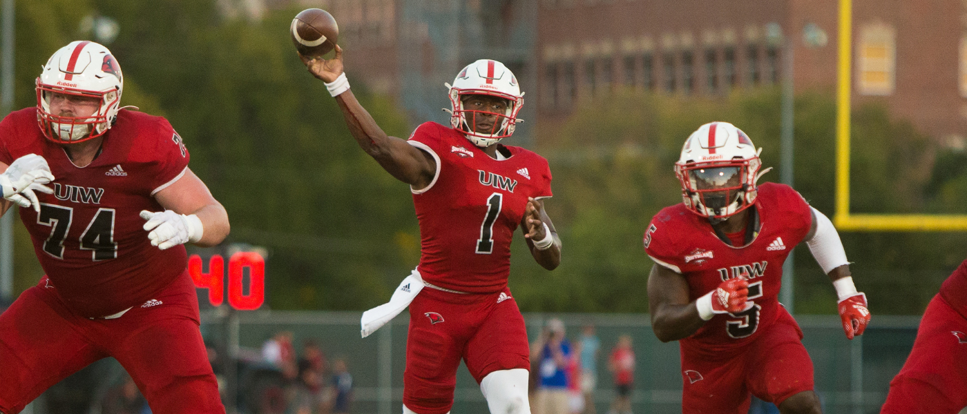 Football student-athlete throwing the ball