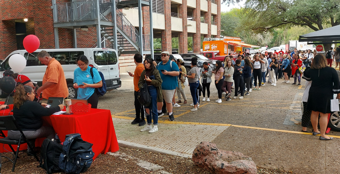 Students waiting in line to get raffle and food tickets