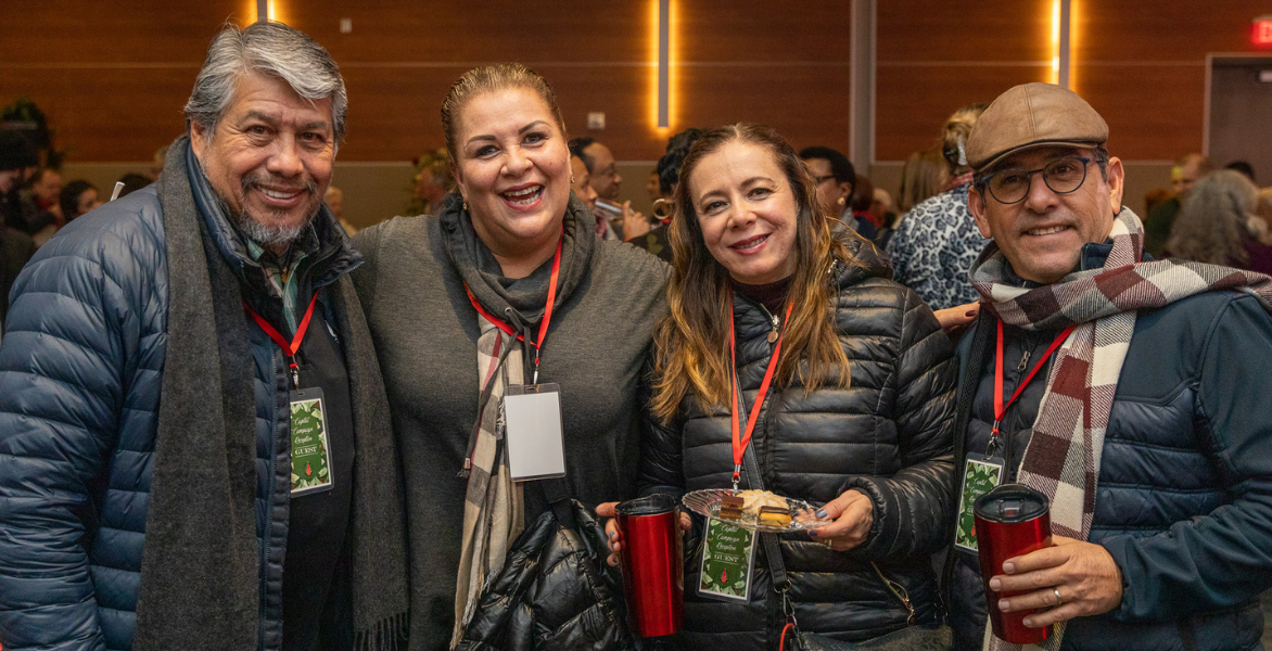 Four adults smiling