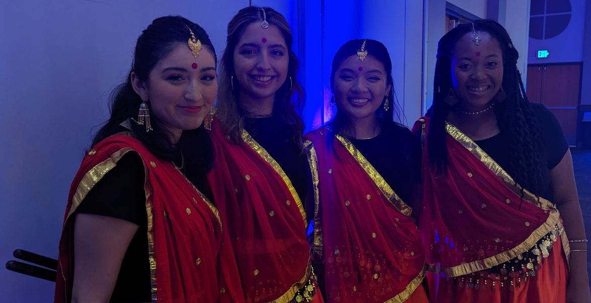 Four women each wearing a Sari