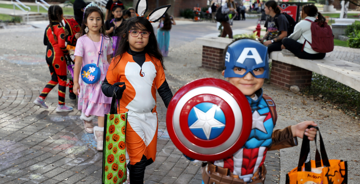 Young children with one dressed as a fox and one dressed as Captain America