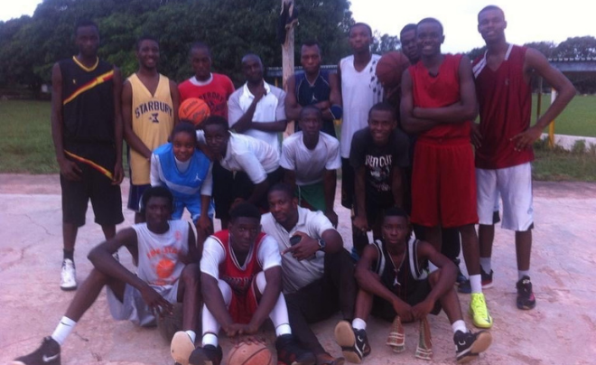 Godsgift "GG" Ezedinma and a group of friends holding basketballs on the basketball court in Nigeria