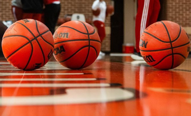 Three basketballs on a basketball court