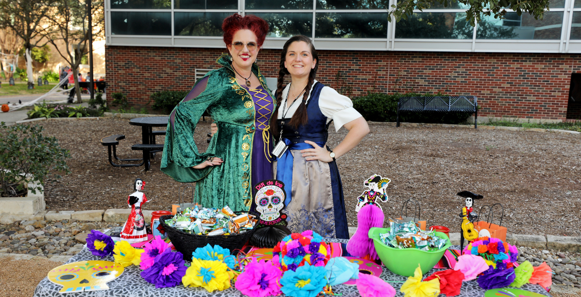 Staff member dressed as Winifred Sanderson from the movie Hocus Pocus and staff member dressed as a German woman for Halloween