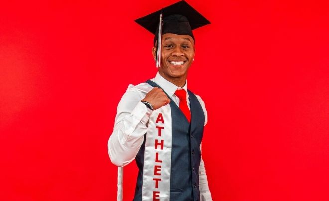 Kyle Lewis poses in cap and gown