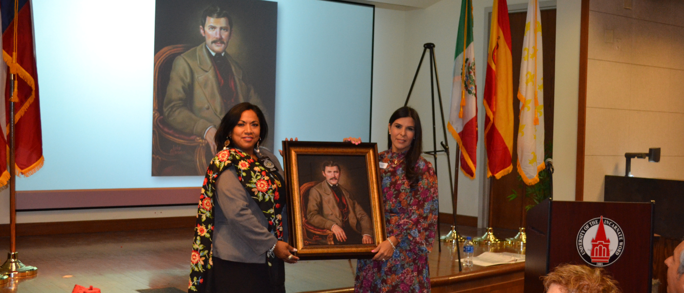 Two women holding a forensic portrait