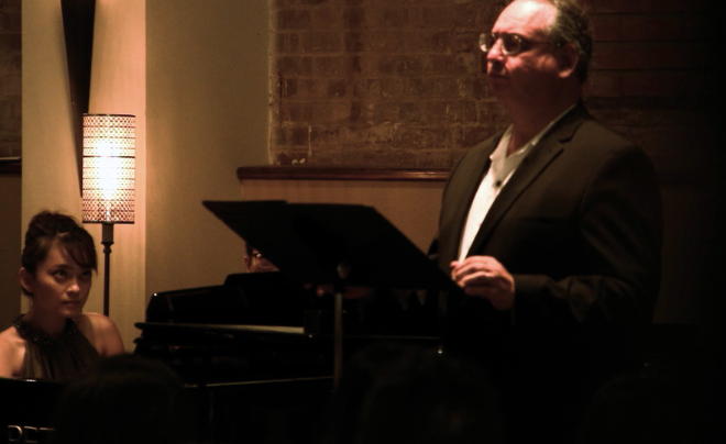 Woman playing piano and man singing