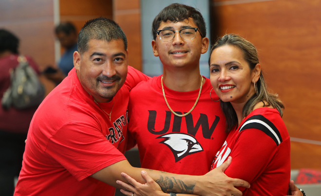 Eddie, Xzavier and Roxanne Perales hugging