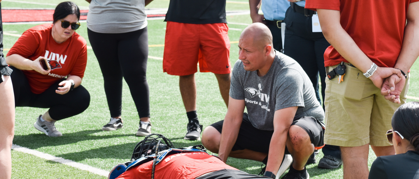 Sal Cervantes working as an athletic trainer