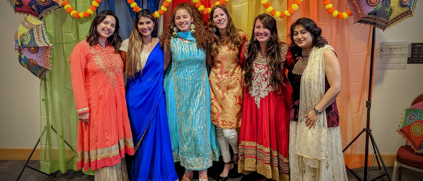 Six women each wearing a Sari