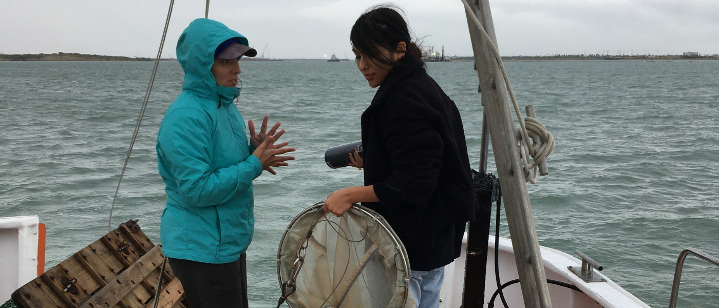 Two women talk on a boat in the bay