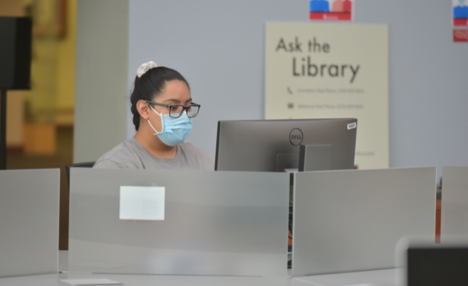 Student studies on a computer in the library