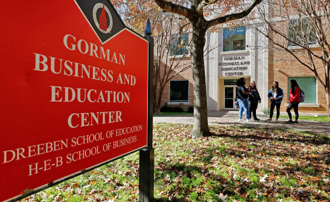 Students talking in front of the Gorman Business and Education Center building