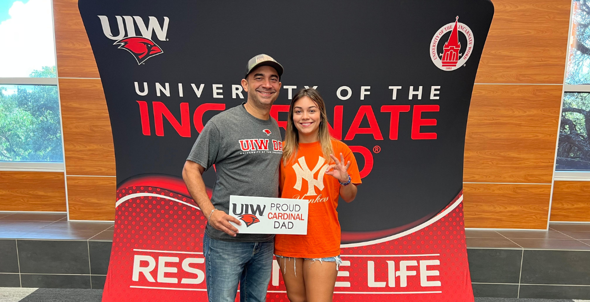 Father and daughter pose together on move-in day