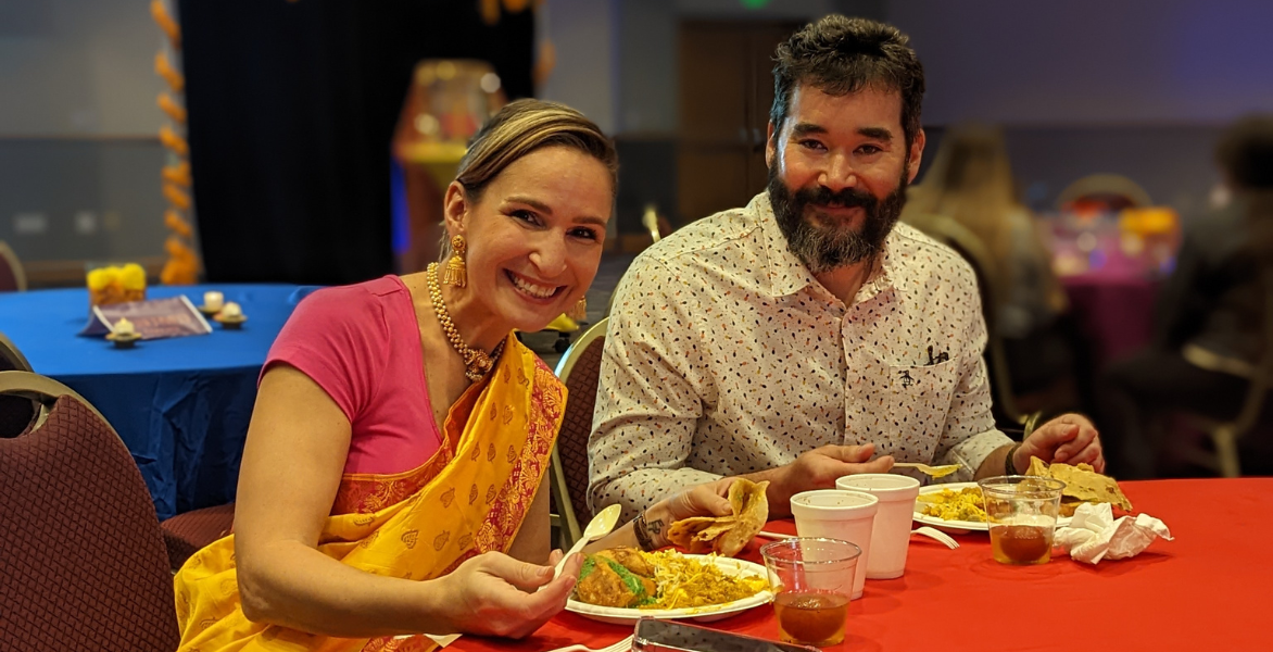 Woman and man smile at the Diwali event