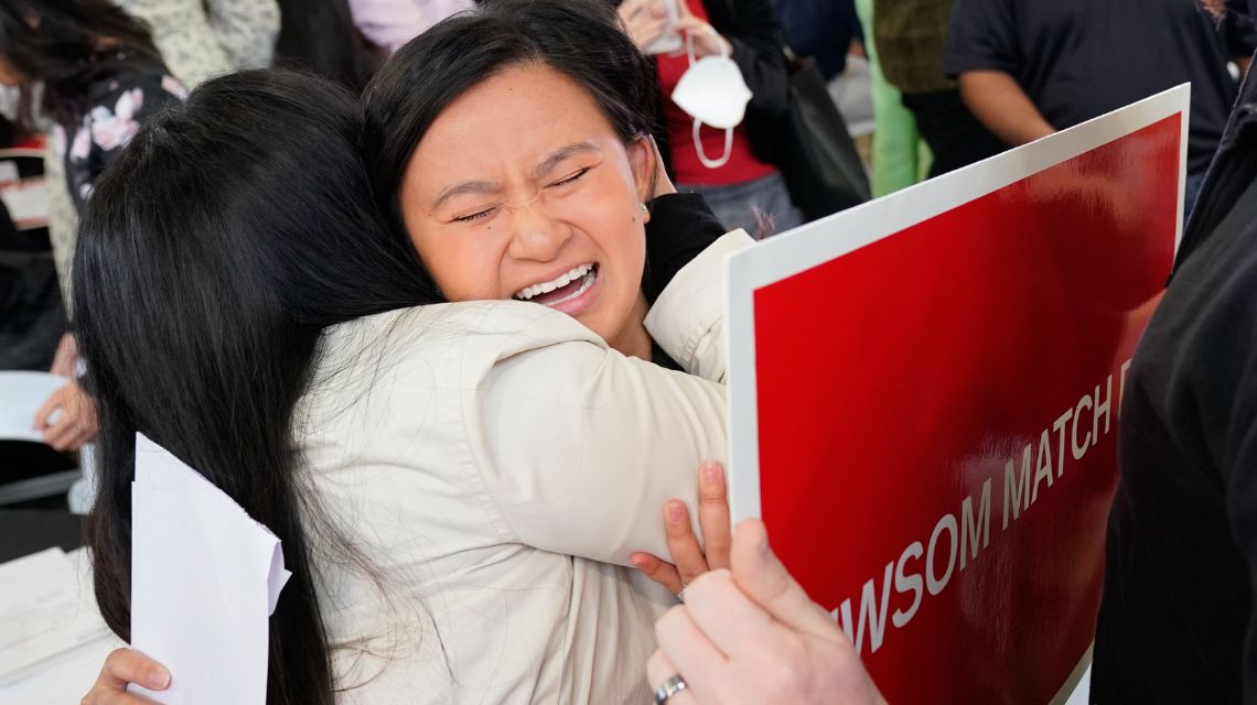 Two women huggin