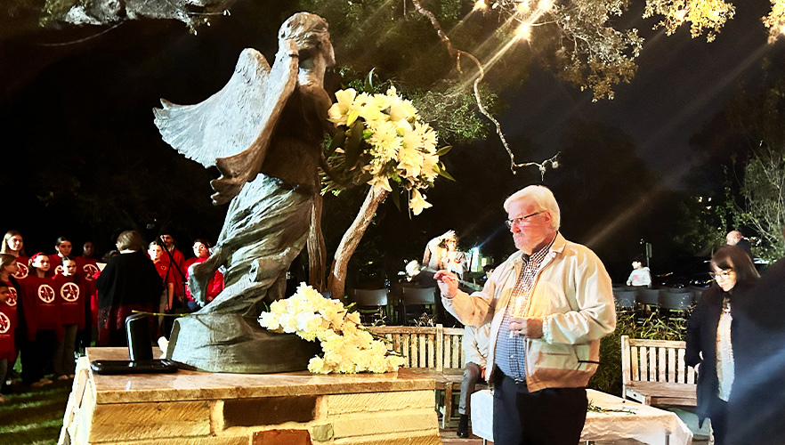 Man praying at Angel of Hope statue