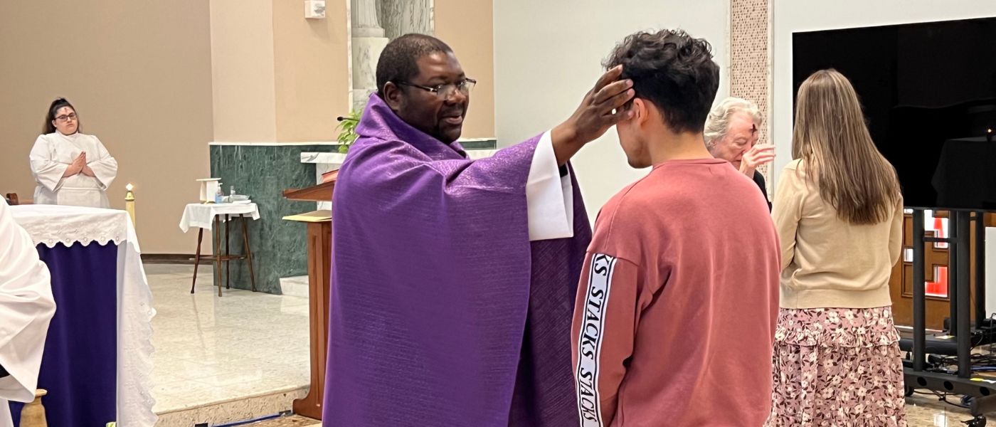 Fr. Hector puts ashes on student's forehead