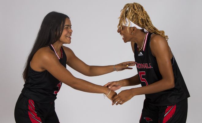 Two women's basketball student-athletes wearing black uniforms