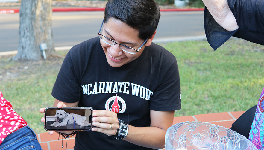 student with dog on phone