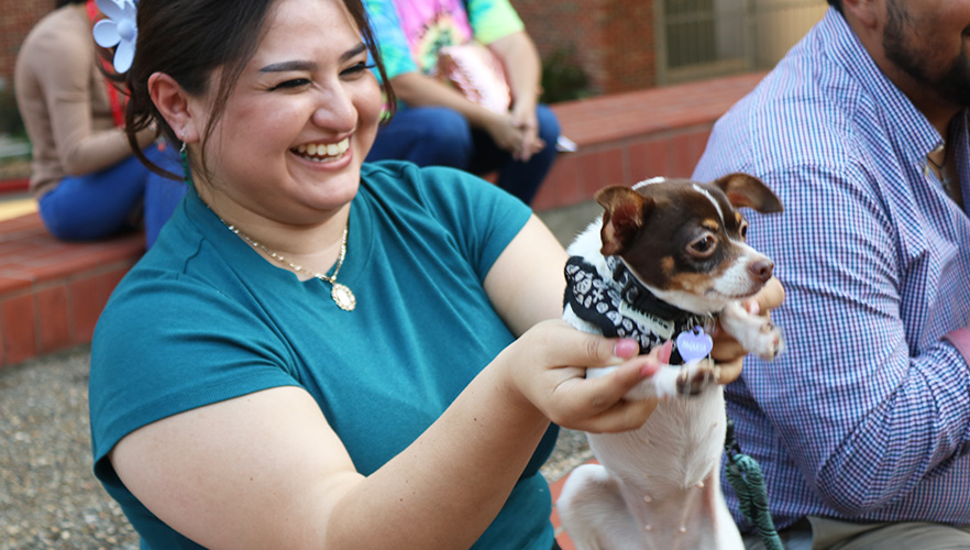 Dog being held for blessing by owner