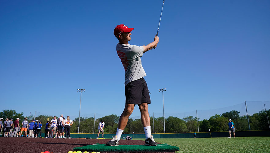 Staff member playing golf