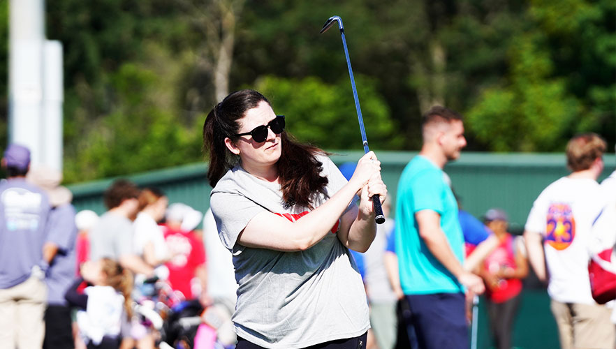 Staff member playing golf