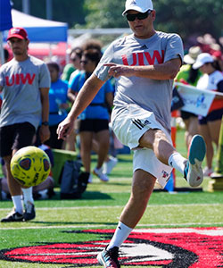 Staff member kicking ball