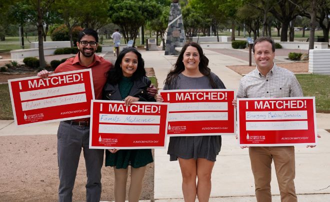 Four people holding signs that say I Matched