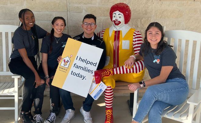 Students with the Ronald McDonald statue