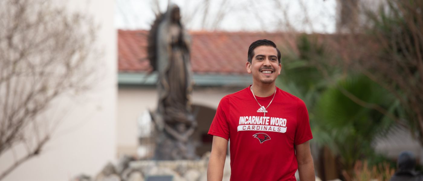 Student wearing UIW shirt and cross necklace
