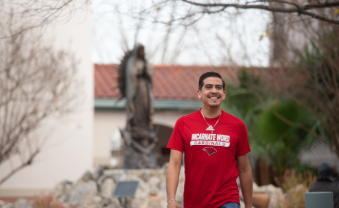 Student wearing UIW shirt and cross necklace
