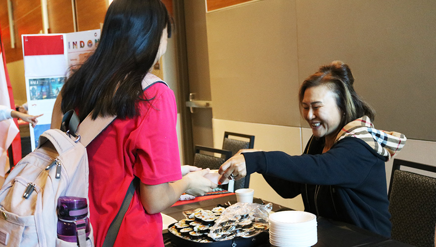 Student at International Education accepting food