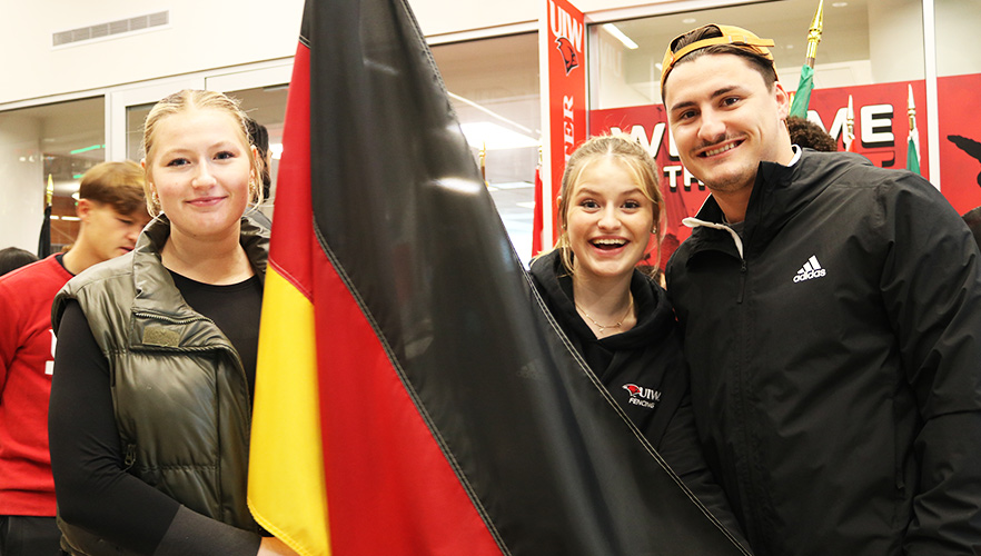 Three students holding flags