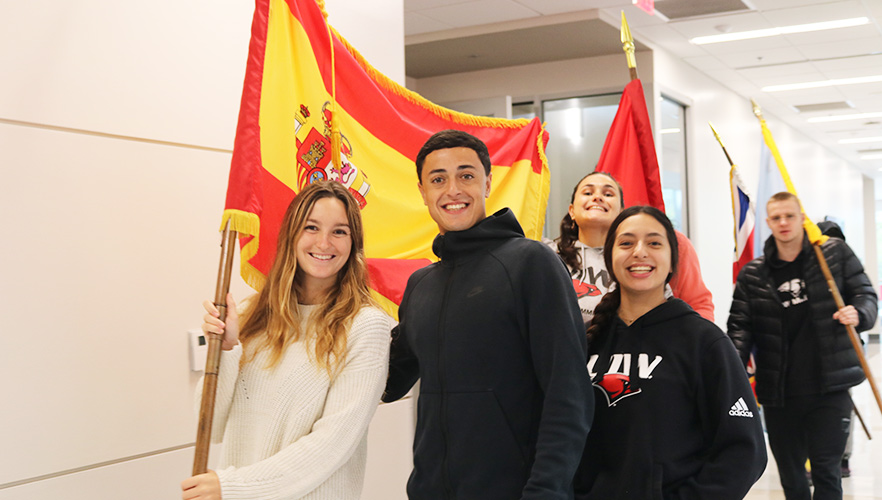 International students carrying flags