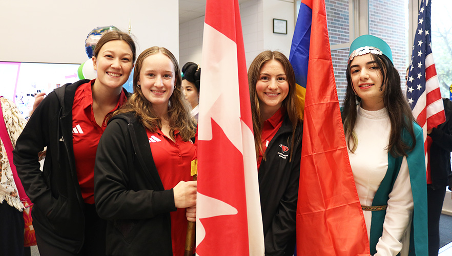 Four students holding flags