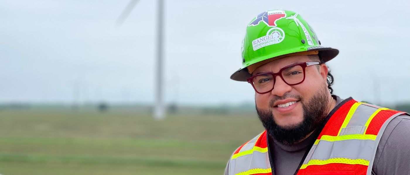 Josh Rangel in front of a windmill