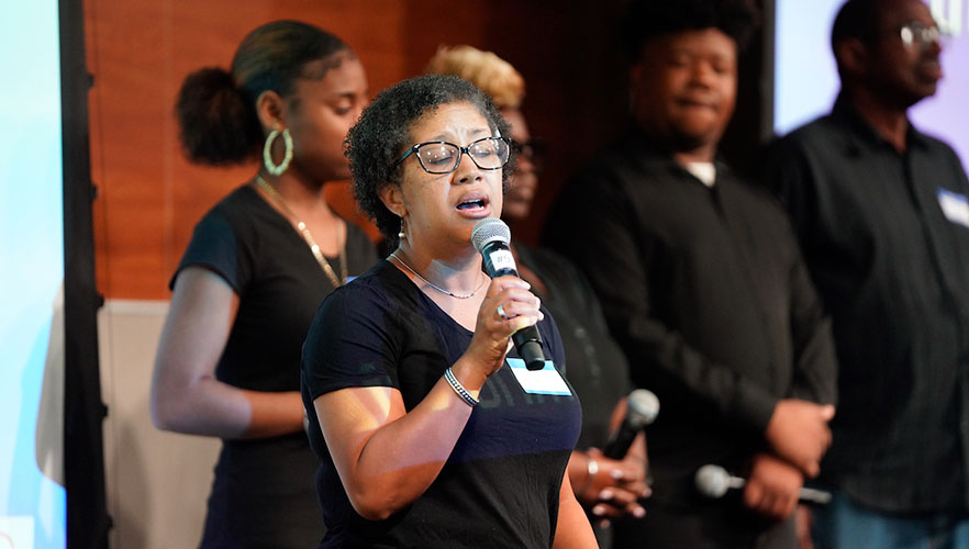 Woman singing at Juneteenth event