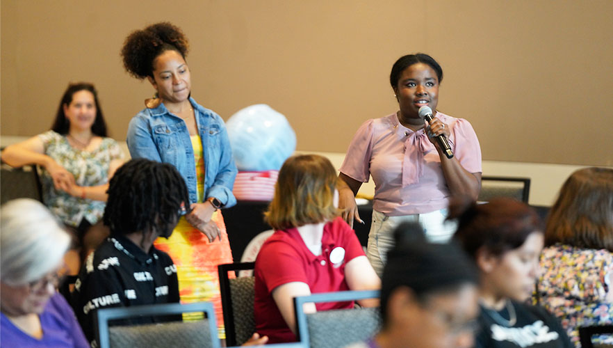 Speaker at Juneteenth event with microphone