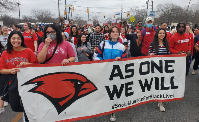 UIW students with a sign that says As One We Will at the MLK March