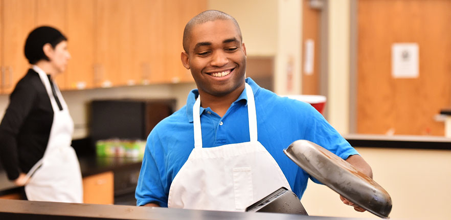 Student cooking in classroom