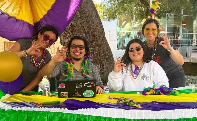 Staff smiling during Pardi Gras