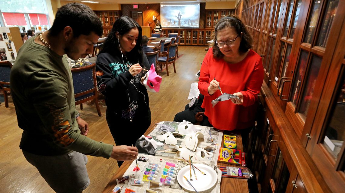 People painting masks