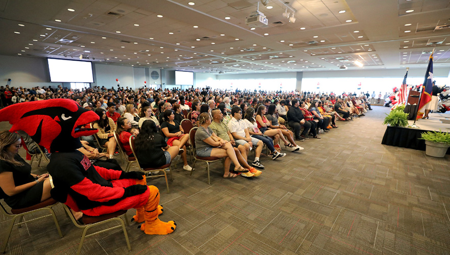 students watching speaker at pinning day