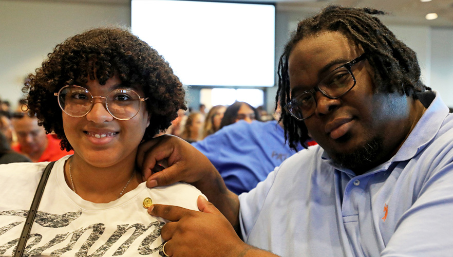 two participants at pinning event