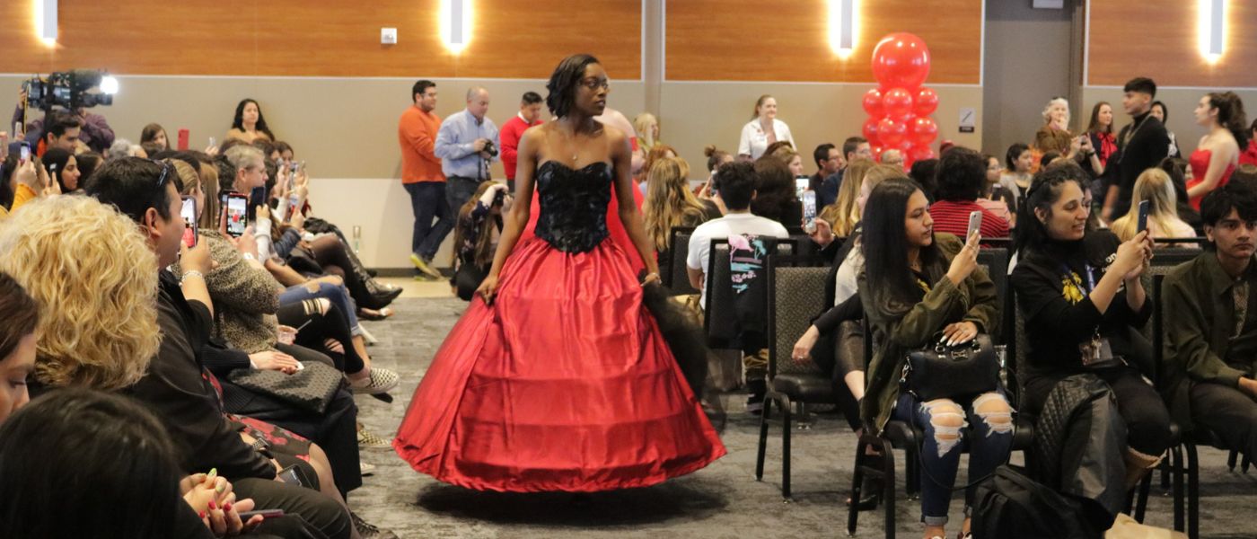 Model displays red and black dress